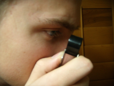 holding hand lens at eye level